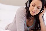 Woman enjoying music in her bedroom