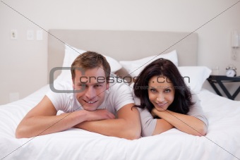 Happy couple laying on the bed together