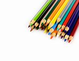 Multi colored pencils in a corner on white background