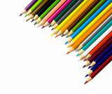 Multi colored pencils in a corner on white background