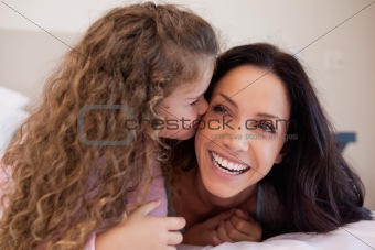 Daughter giving her mother a kiss on the cheek