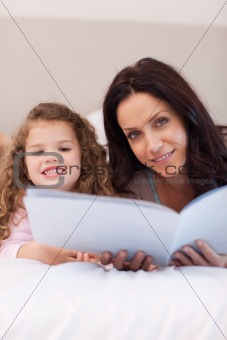 Mother and daughter reading bedtime stories together