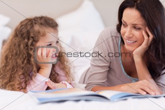 Mother reading a bedtime story for her daughter