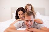 Playful family spending time in the bedroom