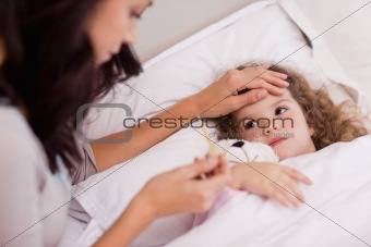 Mother taking care of her sick daughter