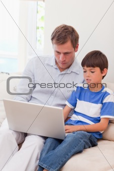 Father and son surfing the internet together