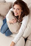 Happy Woman Smiling Hilding Cushion At Home on Sofa