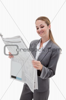 Portrait of a smiling businesswoman reading the news