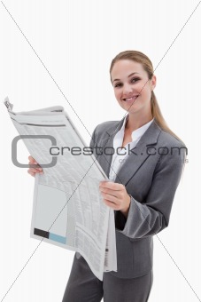 Portrait of a happy businesswoman reading the news