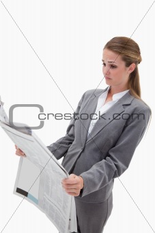 Portrait of a surprised businesswoman reading the news