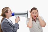 Businesswoman yelling at her coworker through a megaphone