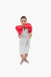 Portrait of a serious businesswoman with boxing gloves
