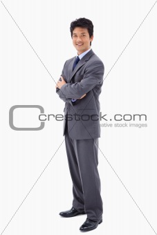 Portrait of a smiling businessman with the arms crossed