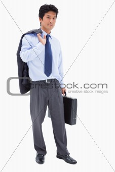 Portrait of a businessman holding a briefcase and his jacket on his shoulder