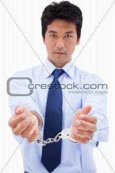 Portrait of a businessman with handcuffs