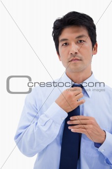 Portrait of a businessman fixing his tie