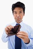 Portrait of a businessman showing his empty wallet
