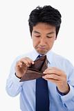 Portrait of a sad businessman showing his empty wallet