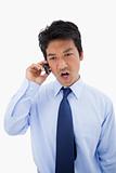 Portrait of an angry businessman making a phone call