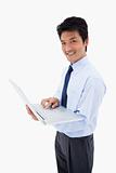 Portrait of a smiling businessman using a laptop