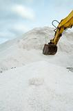 Excavator digging pile salt