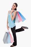 Portrait of a cheerful woman posing with shopping bags