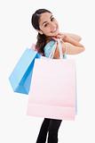 Portrait of a smiling woman posing with shopping bags