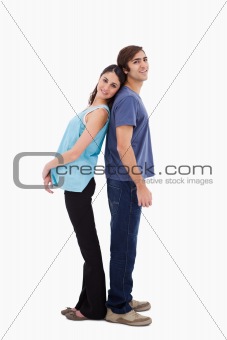 Portrait of a young couple standing back to back