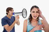 Man shouting at her girlfriend through a megaphone