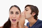 Man whispering something shocking to his fiance