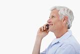 Side view of a smiling mature man making a phone call