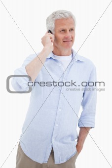 Portrait of a smiling mature man using his mobile phone