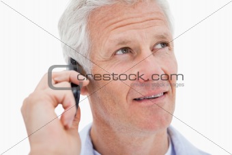 Mature man making a phone call while looking up