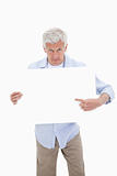 Portrait of a mature man pointing at a blank board