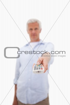 Portrait of a mature man using a remote
