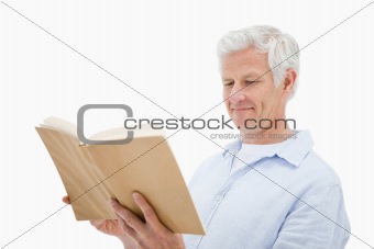Happy mature man reading a book