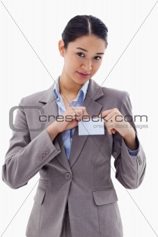 Portrait of a young businesswoman clipping her badge