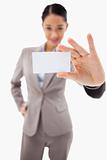 Portrait of a cute businesswoman showing a blank business card