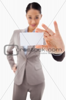 Portrait of a cute businesswoman showing a blank business card