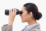 Side view of a businesswoman looking through binoculars