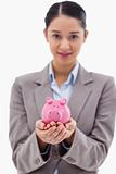 Portrait of a businesswoman holding a piggy bank