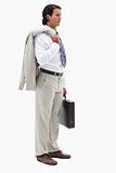 Portrait of a serious office worker holding his jacket over his shoulder and a briefcase