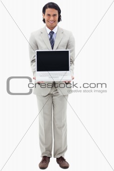 Portrait of a smiling businessman showing a notebook