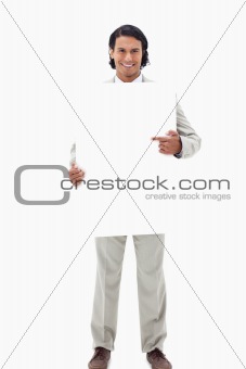 Businessman pointing at blank sign in his hands
