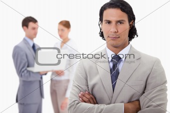 Businessman with colleagues working on laptop