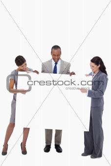 Businesspeople pointing and looking at blank sign