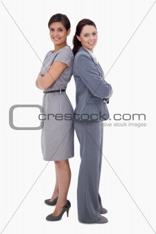 Businesswomen standing back on back