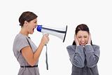 Businesswoman yelling at colleague with megaphone