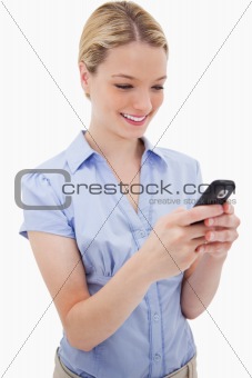 Smiling woman writing text message