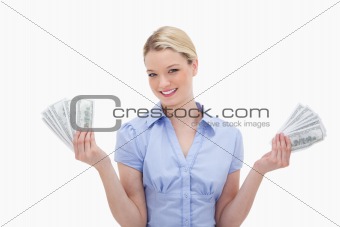 Smiling woman holding money in her hands
